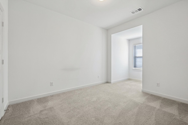 unfurnished room with light colored carpet