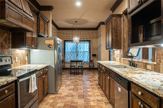 kitchen featuring decorative backsplash, sink, custom range hood, pendant lighting, and appliances with stainless steel finishes