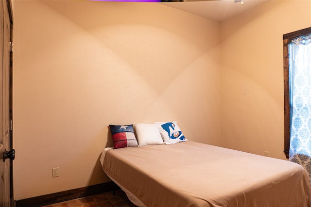 bedroom featuring dark tile patterned floors