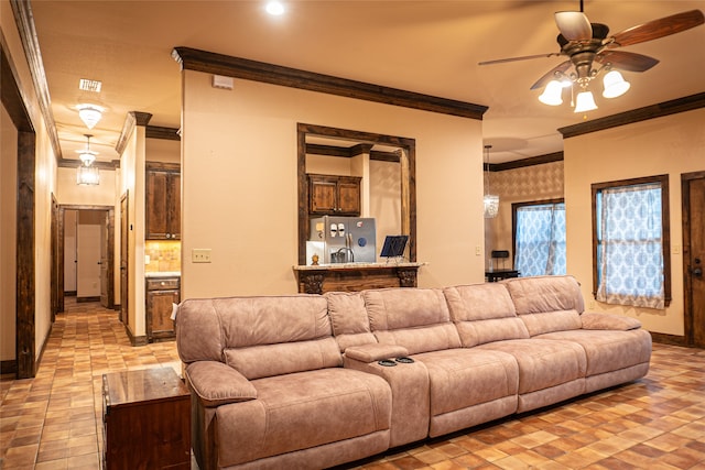 living room featuring ceiling fan and crown molding