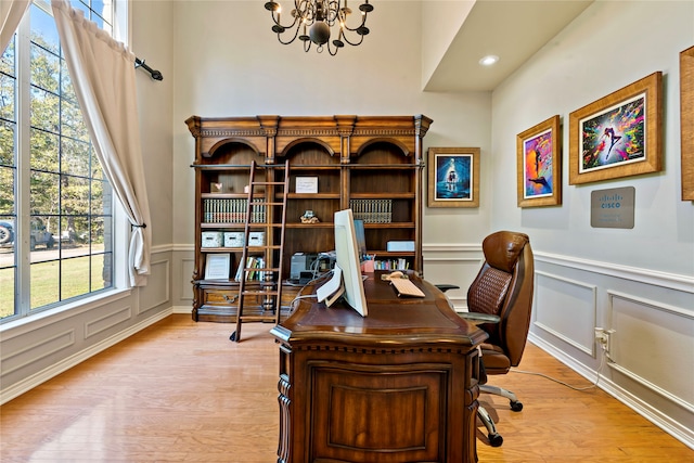 office featuring a chandelier and light hardwood / wood-style flooring