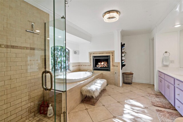 bathroom featuring a tiled fireplace, tile patterned floors, plus walk in shower, vanity, and crown molding