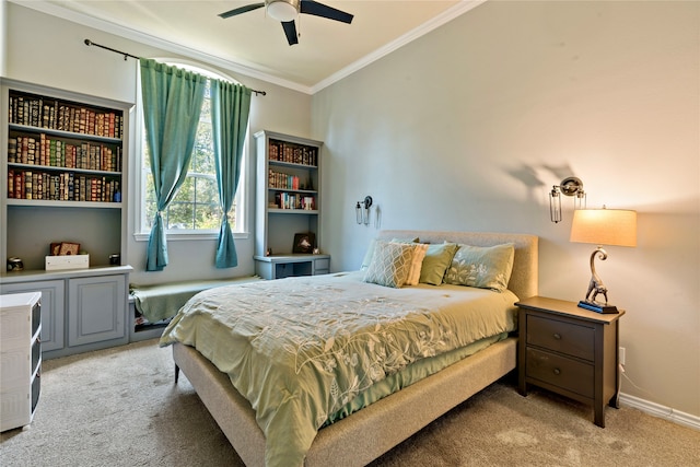 carpeted bedroom with ornamental molding and ceiling fan