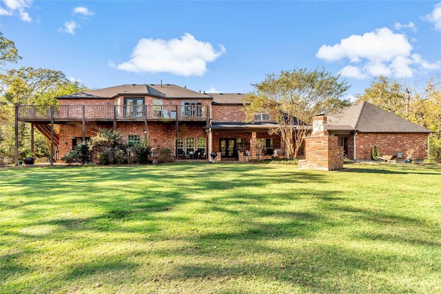 rear view of property with a lawn