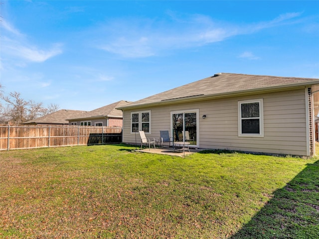 back of house with a lawn and a patio