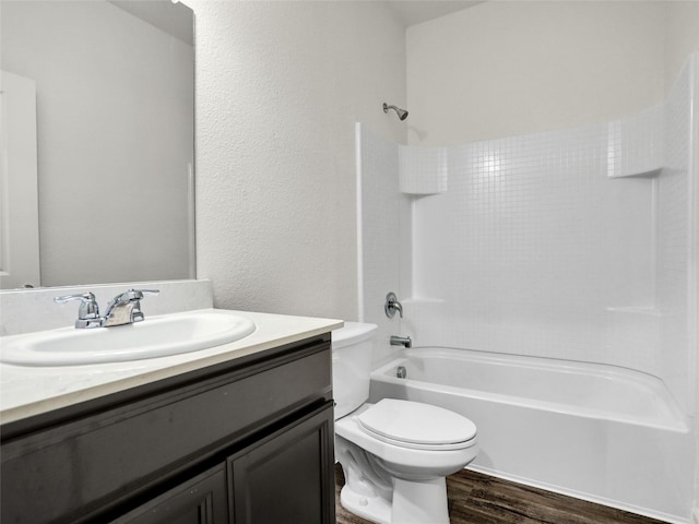 full bathroom featuring vanity, hardwood / wood-style floors, shower / tub combination, and toilet