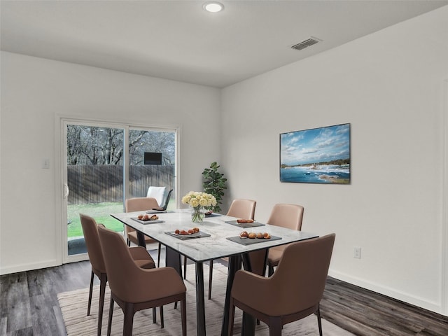 dining space with dark wood-type flooring