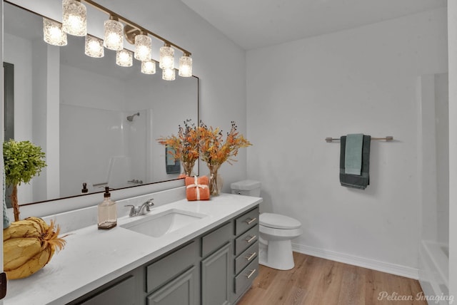 bathroom featuring wood-type flooring, vanity, and toilet