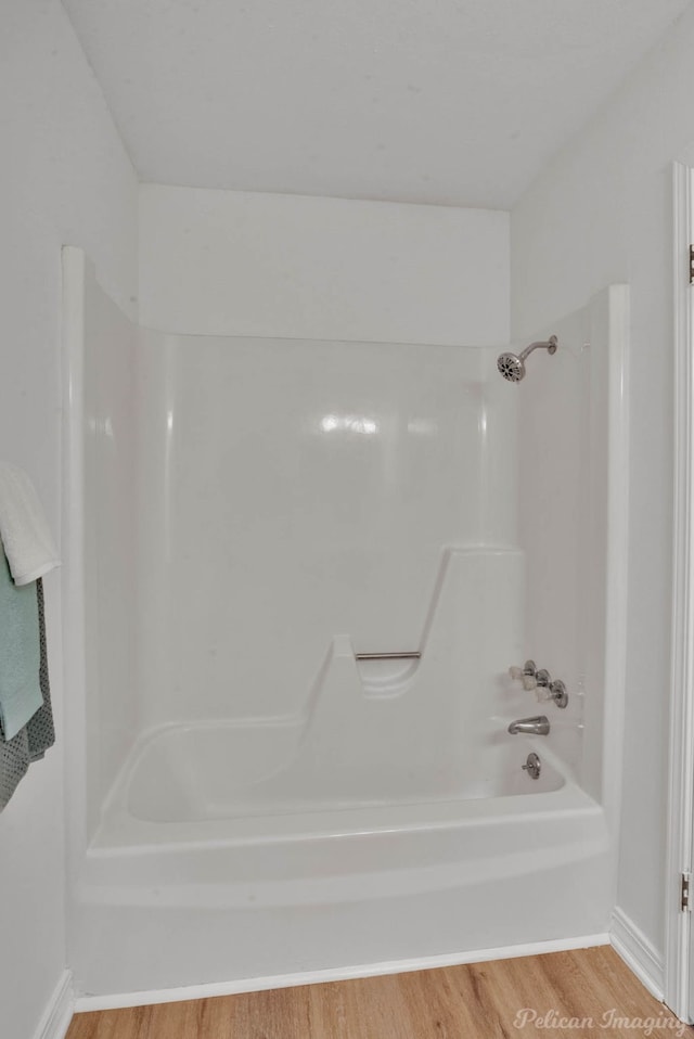 bathroom featuring shower / bath combination and wood-type flooring