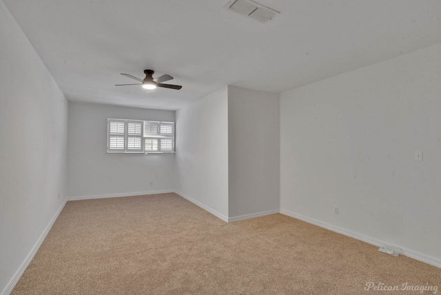 carpeted spare room with ceiling fan