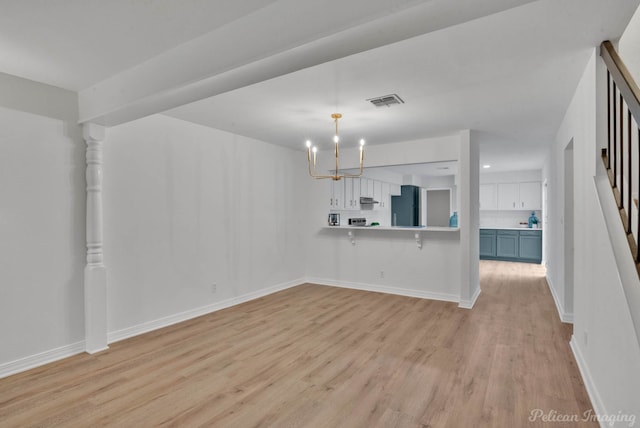 interior space featuring light hardwood / wood-style floors and a chandelier