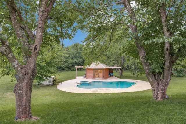 view of pool with a lawn, a pool with connected hot tub, and a patio