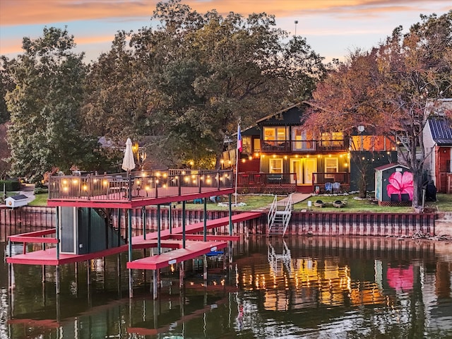 dock area featuring a water view and a balcony