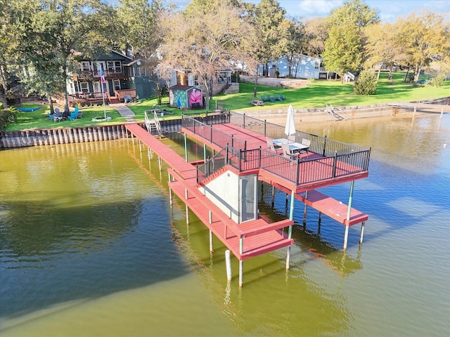 view of dock featuring a lawn and a deck with water view