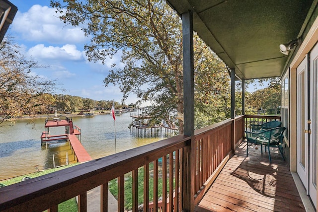 balcony featuring a water view and a boat dock