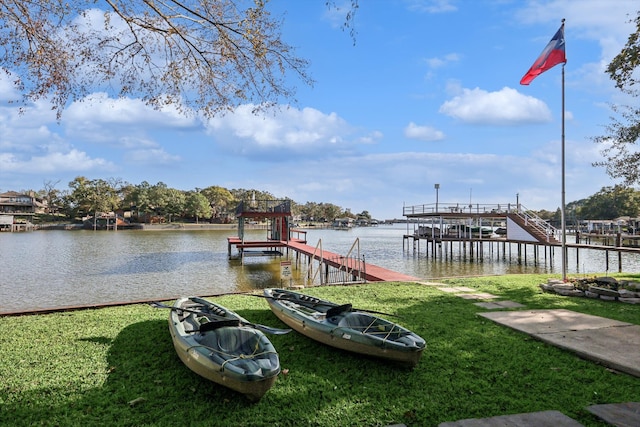 dock area with a water view and a yard