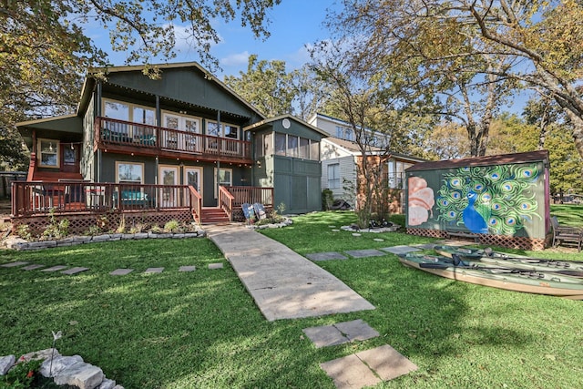 back of house with a yard and a wooden deck