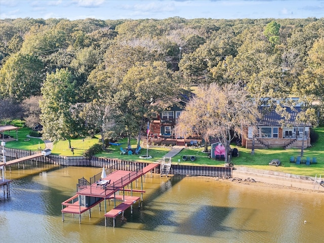 view of dock featuring a yard and a deck with water view