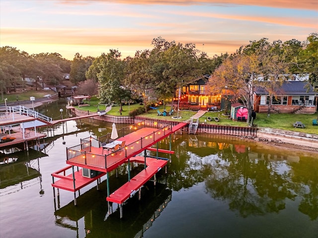 dock area featuring a water view and a yard