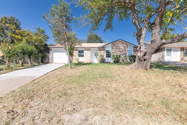 ranch-style home with a garage and a front yard