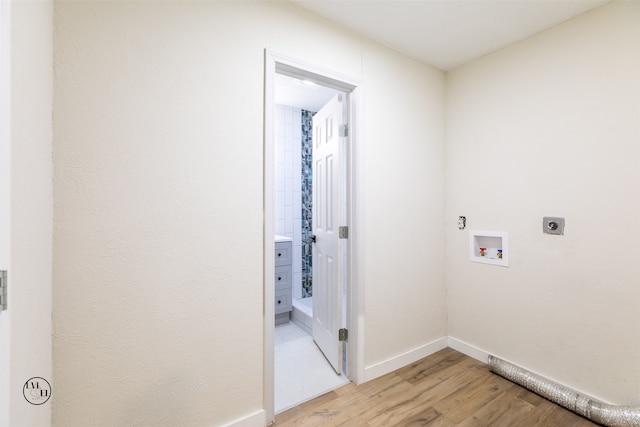 clothes washing area featuring light hardwood / wood-style floors, hookup for an electric dryer, and washer hookup