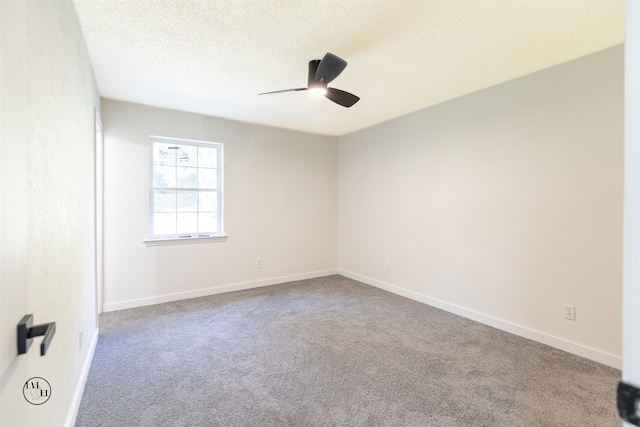 carpeted empty room featuring ceiling fan and a textured ceiling