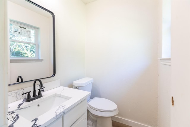 2318 May Ln, Grand Prairie, TX 75050 - bathroom with toilet, vanity, and baseboards