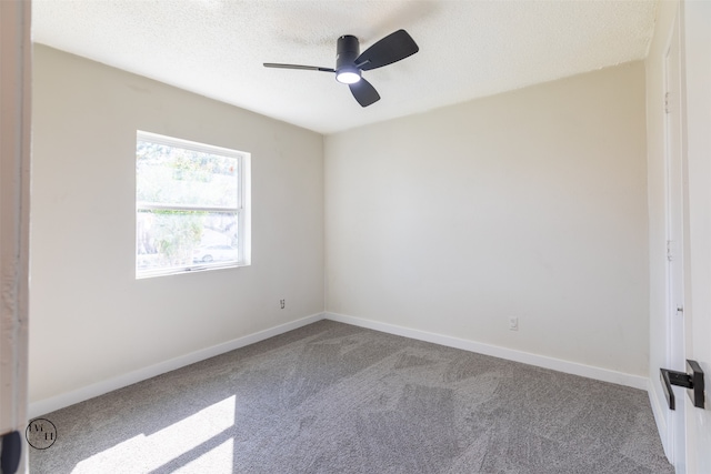 carpeted empty room with a textured ceiling and ceiling fan