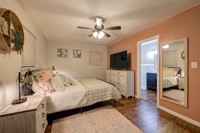 bedroom featuring ceiling fan, ensuite bath, and dark hardwood / wood-style flooring