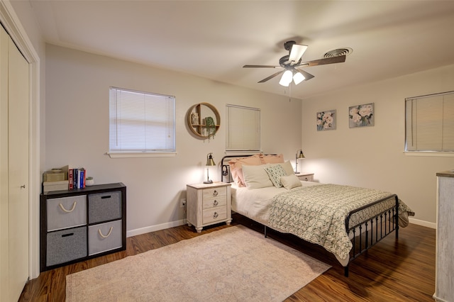 bedroom with a closet, ceiling fan, and dark hardwood / wood-style floors