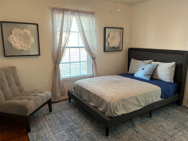 bedroom with dark hardwood / wood-style floors and multiple windows