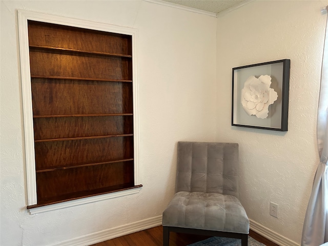 sitting room with hardwood / wood-style flooring and a textured ceiling