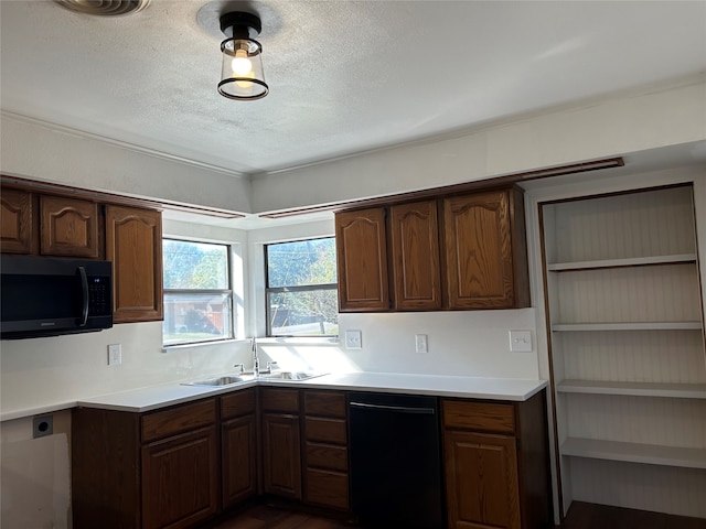 kitchen with a textured ceiling, dark hardwood / wood-style flooring, black appliances, and sink