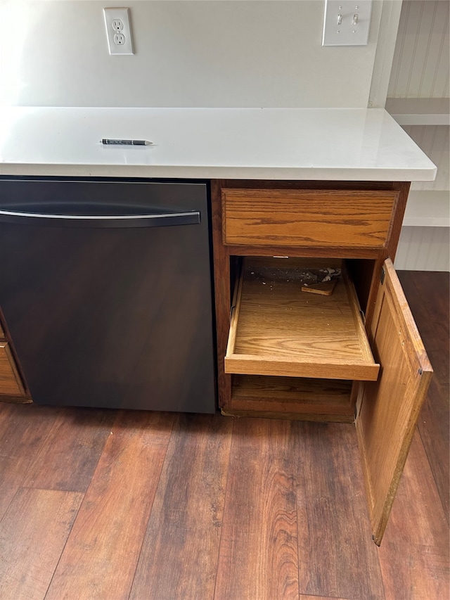 room details featuring dark hardwood / wood-style flooring and stainless steel dishwasher