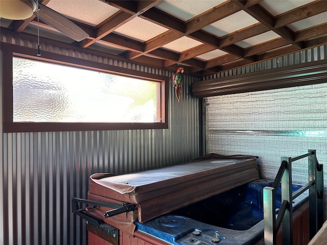 interior space featuring a jacuzzi, beam ceiling, and coffered ceiling