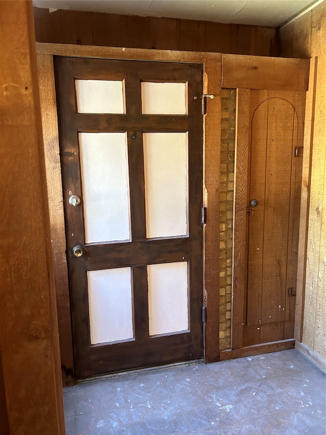 entryway featuring wooden walls