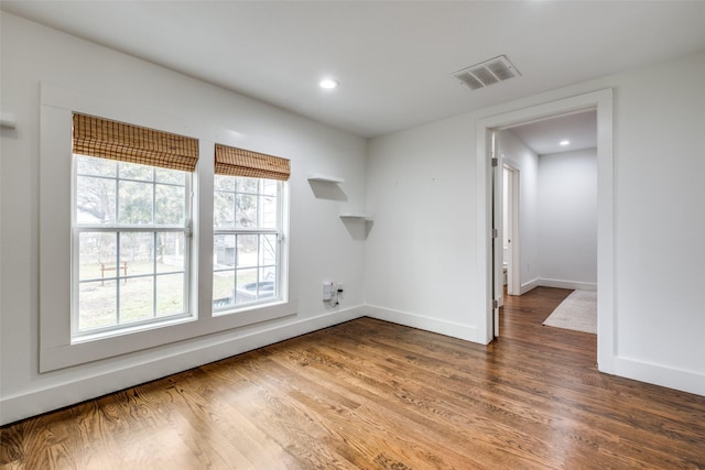 unfurnished room with dark hardwood / wood-style flooring