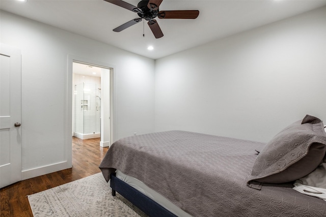 bedroom with ceiling fan, dark hardwood / wood-style flooring, and connected bathroom