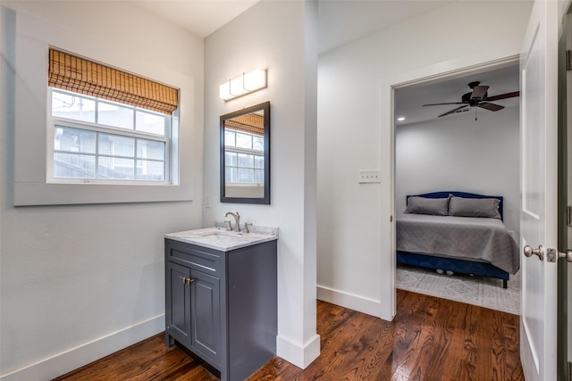 bathroom featuring ceiling fan, wood-type flooring, and vanity