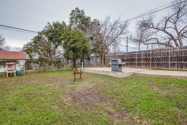 view of yard with a patio area and a playground