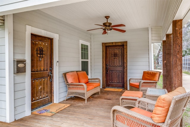 doorway to property featuring ceiling fan and a porch