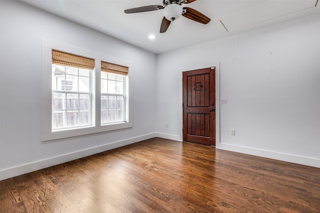 spare room featuring ceiling fan and dark hardwood / wood-style flooring