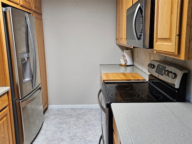 kitchen with stainless steel appliances and backsplash