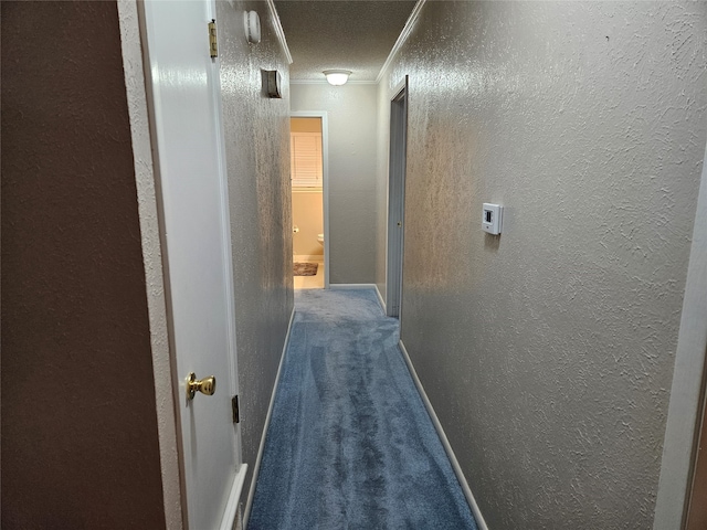 corridor featuring dark colored carpet and ornamental molding