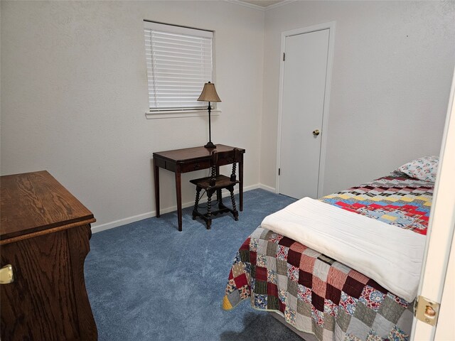 bedroom featuring dark colored carpet and crown molding