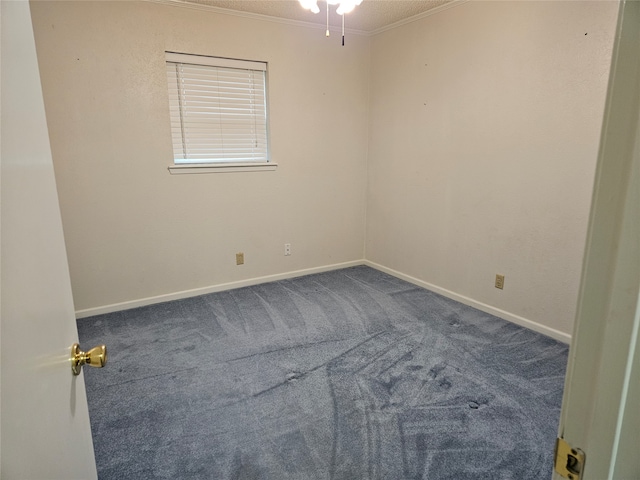 carpeted spare room featuring ornamental molding and ceiling fan