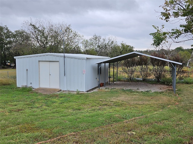 view of outbuilding featuring a yard and a carport