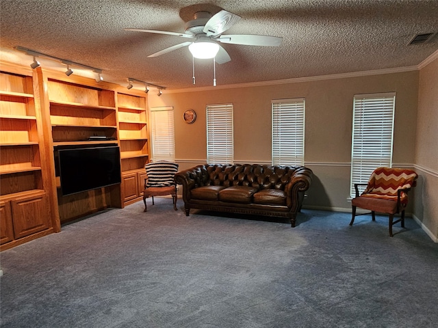 living room with carpet flooring, a textured ceiling, crown molding, and ceiling fan