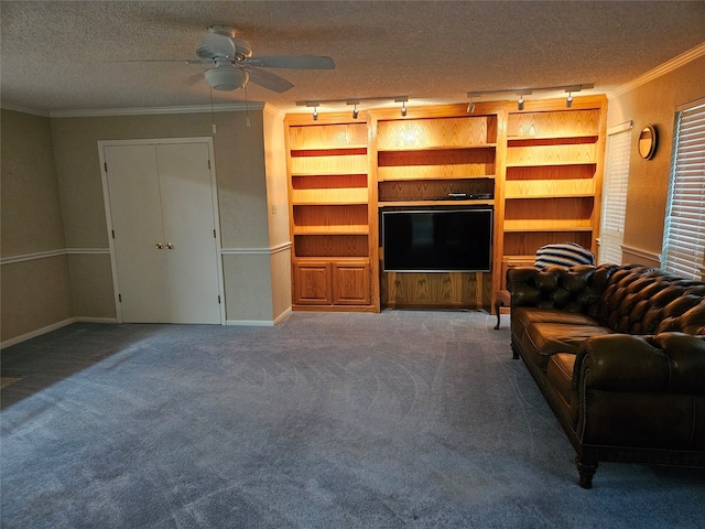 unfurnished living room with carpet, ornamental molding, track lighting, a textured ceiling, and ceiling fan