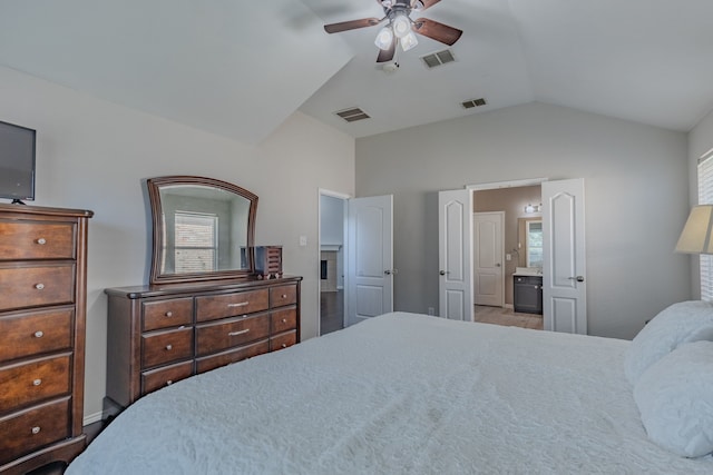 bedroom with ensuite bath, lofted ceiling, and ceiling fan